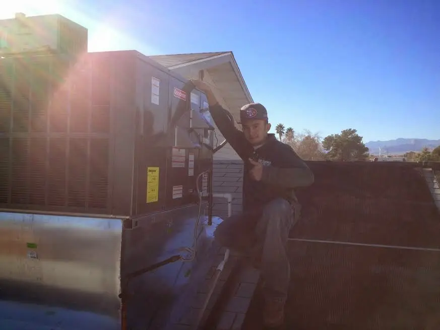 HVAC technician performing HVAC Inspection on a rooftop unit in Jeannette